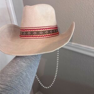 Cream cowgirl hat with hat band and pearl hat chain